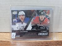 Front view of 2015 Upper Deck Young Guns checklist card in protective sleeve
