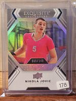 Front view of 2022 Upper Deck Exquisite Collection Nikola Jovic rookie card serial 009/149 in case
