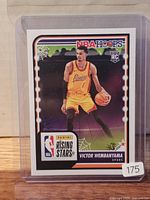 Front of Victor Wembanyama rookie card in protective sleeve and top loader