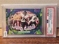 Front of PSA-slabbed 2024 Panini Rookies & Stars Artistry In Motion Green Bijan Robinson card showing artwork, serial number, PSA label indicating Mint 9