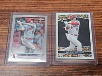 Front view of two Shohei Ohtani baseball cards in top loaders