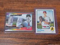 Two Shohei Ohtani baseball cards, one Flashiest Feet insert in sleeve, one Topps Heritage base