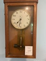 Clock inside oak case with glass door closed