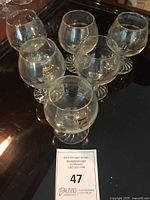 Five of the six gold-rimmed Petro-Canada Calgary 1988 Olympic snifter glasses on tray