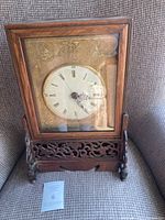 Front view showing dial, case and stand