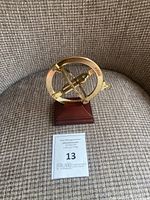 Front angled view of brass ring dial sundial on wood base