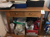 Front view of hall table showing top, two drawers, legs