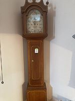 Full view of tall wooden grandfather clock