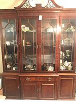 Front view of mahogany breakfront china cabinet showing entire piece
