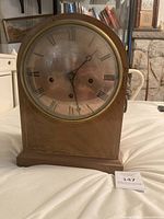 Front view of wood mantel clock
