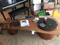 Full view of teak coffee table with contents on top