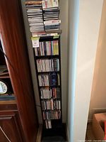 Full view of tall CD tower shelf filled with discs
