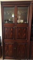 full view of tall wood cabinet showing all doors