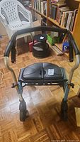 Front view of Evolution Xpresso rollator walker showing seat and handles