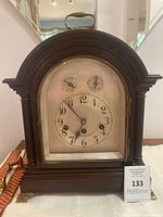 Front view showing dial, case design and brass feet