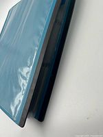 Closed blue Staples binder, showing thickness