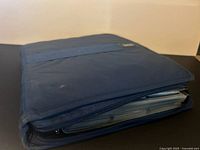 Blue fabric zipper binder closed