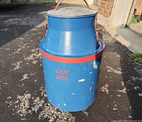 Full view of blue CNR water can with red band and stencil