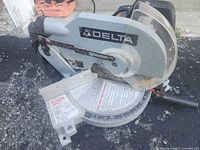 Full view of Delta compound miter saw with blade guard and angle base