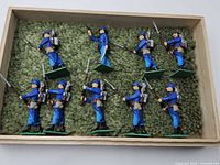 Full view of nine Foreign Legion lead soldiers in wooden tray