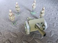 Group shot of four soldiers and field cannon