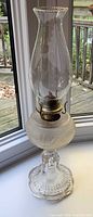 Full view of oil lamp showing glass body and chimney
