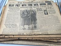 Stack of wartime newspapers, top issue The Evening Telegram, visible date 1940
