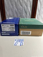 Birkenstock and Clarks shoe boxes with size labels visible