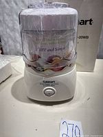 Front view of Cuisinart frozen dessert maker with lid and freezer bowl