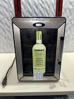 Front view showing glass door, brand logo, interior racks and promotional insert