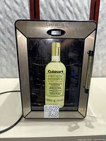 Front view of Cuisinart wine cooler showing door, handle, and branding