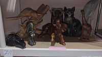 All eight figurines displayed on shelf