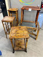 All five bamboo-rattan tables and plant stands grouped