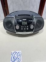 Front view of RCA boombox showing speakers, controls and cassette slot