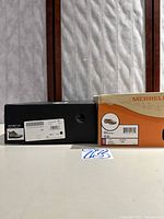 Two original shoe boxes with size 7 labels (Sorel and Merrell)