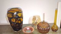 All five amber glass pieces together on shelf
