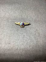 Front view showing winged design and enamel logo