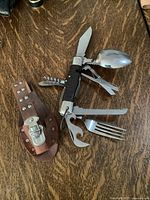 Multi-tool open with sheath beside