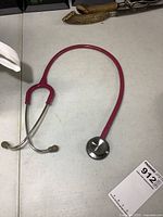 Pink Littmann stethoscope full view on table