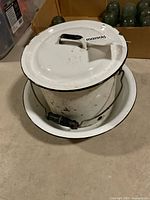 Chamber pot with lid beside basin, showing exterior