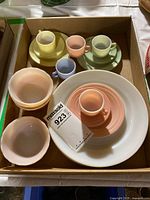Assortment of pastel cups, saucers, bowls and white plates in box