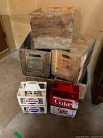 Stacked wood crates and plastic soda carriers