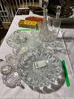 Overall lot view showing decanters, stemware, serving pieces