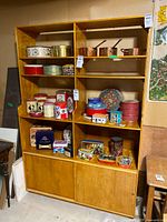 Full view of display cabinet showing open shelving and sliding door base