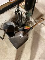 Group of fireplace tools, ash scuttle, coal shovel, kettles and oil lantern