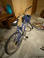 Full view of blue step-through Raleigh Summit bicycle