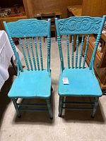 Front view of both turquoise pressed back chairs