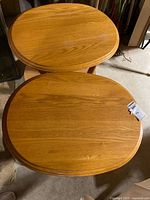 Top view of both oak side tables showing oval shape and wood grain