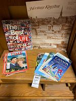 Overview showing The Best of Life book, Heritage Kingston poster and stack of assorted magazines