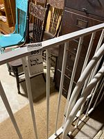 White steel bed frame components standing upright